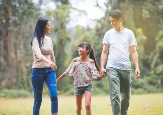  three-people-walking-in-park